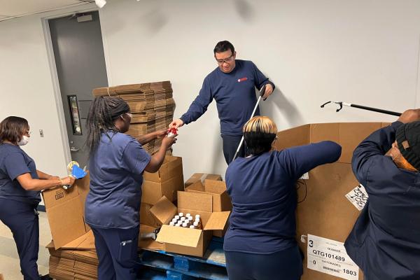 Yamaha team members sort drinks and repack on pallets. The volunteer stations at the Yamaha plant allow team members to continue working during downtime while the processed and sorted drink boxes benefits Midwest Food Bank operations. 